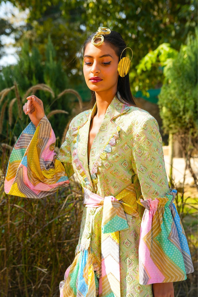 Closeup of Noor Blazer Dress showing embroidered silk fabric, leaf lace collar, and pastel Bandhani accents.