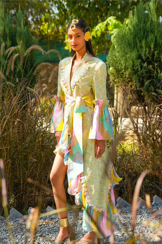 Full-length view of model in Noor Blazer Dress, showcasing pastel embroidery, ruffled hem, and voluminous sleeves.